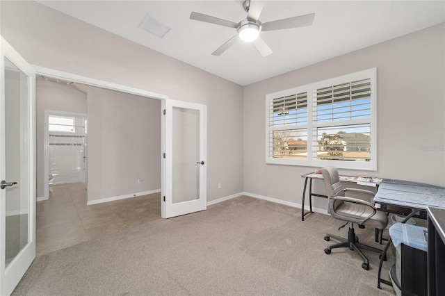 carpeted office with ceiling fan and french doors