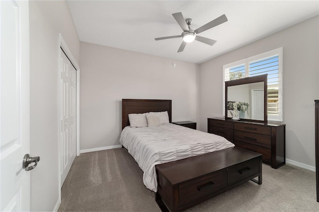 carpeted bedroom with ceiling fan and a closet