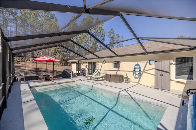 view of pool featuring a patio area and glass enclosure