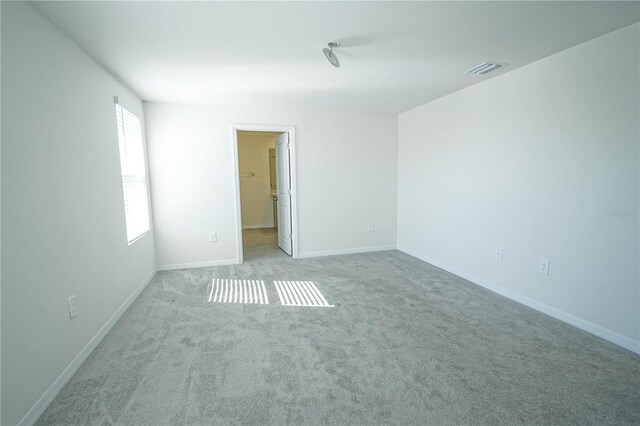 unfurnished bedroom featuring visible vents, baseboards, and carpet floors