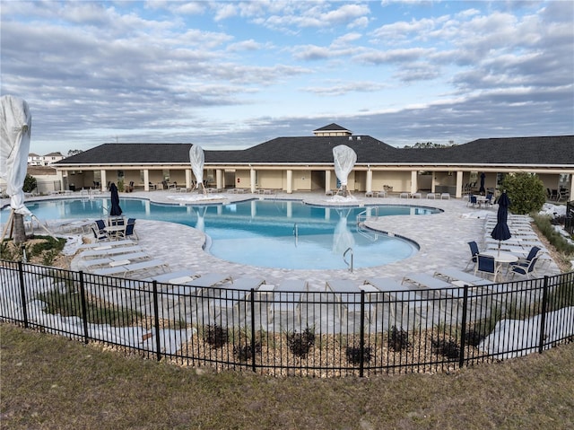 pool featuring a patio and fence