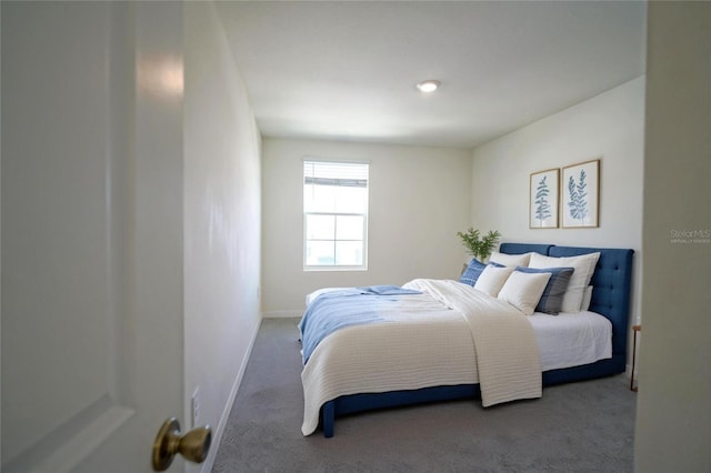 bedroom with baseboards and carpet flooring