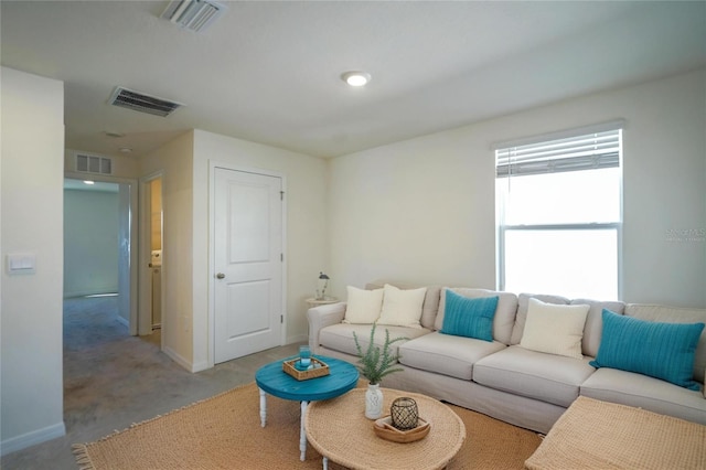 living room featuring visible vents, light colored carpet, and baseboards