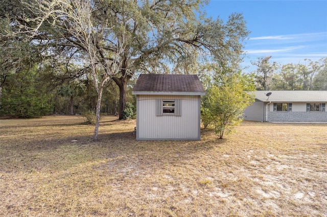 view of outbuilding featuring a lawn