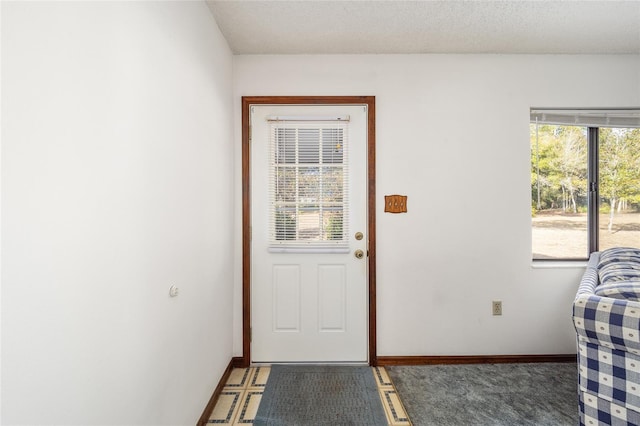 entryway with a textured ceiling