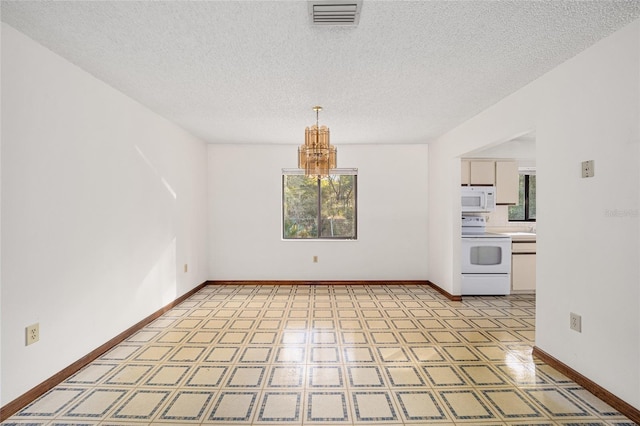 spare room with a textured ceiling