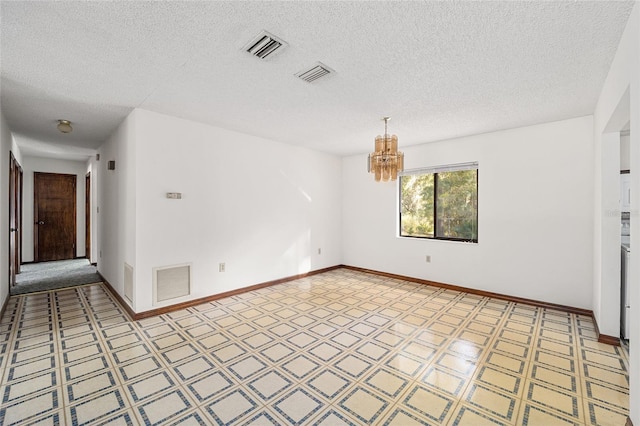 unfurnished room featuring a textured ceiling