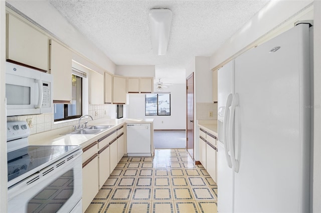 kitchen featuring tasteful backsplash, sink, white appliances, and a textured ceiling