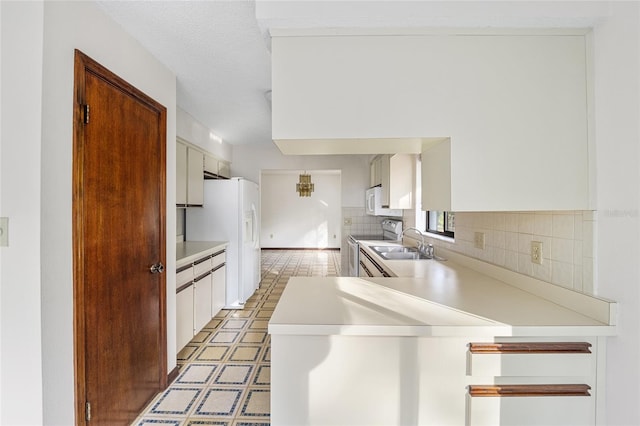 kitchen featuring white cabinetry, sink, decorative backsplash, white appliances, and a textured ceiling