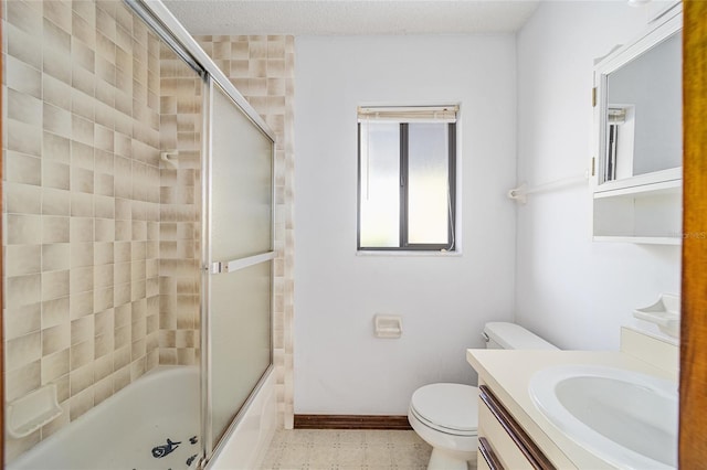 full bathroom featuring vanity, bath / shower combo with glass door, and toilet