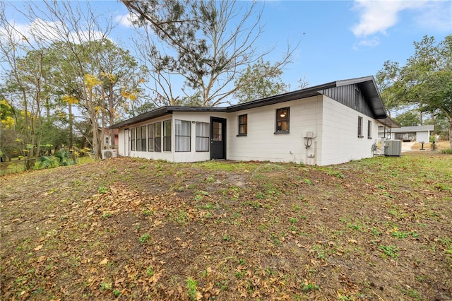 back of property featuring a sunroom and central air condition unit