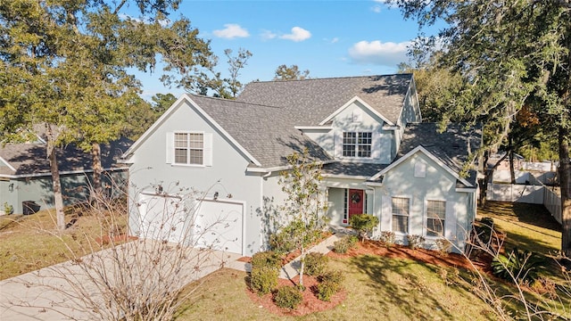 view of front of home featuring a garage and a front lawn