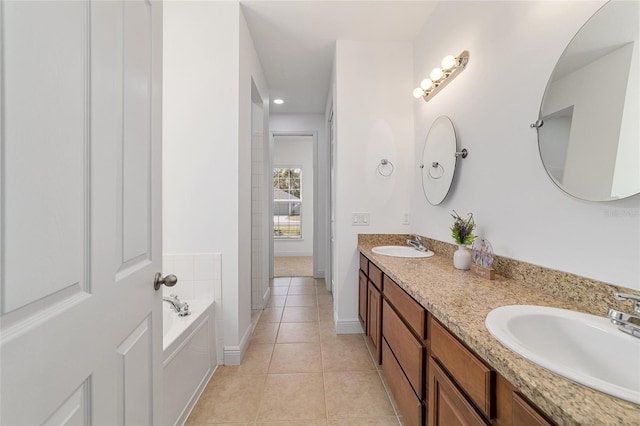 bathroom with vanity, a tub, and tile patterned floors