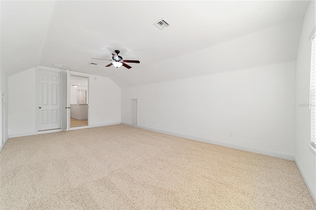 additional living space featuring vaulted ceiling, carpet floors, and ceiling fan