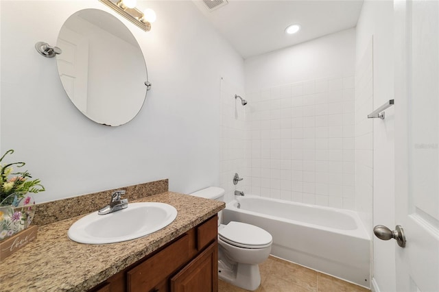 full bathroom featuring vanity, tile patterned flooring, tiled shower / bath combo, and toilet