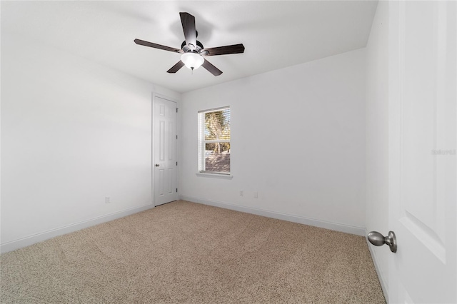 spare room with ceiling fan and carpet