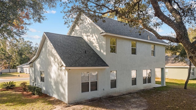 rear view of property with a yard