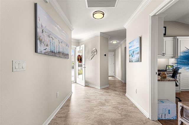 hall featuring ornamental molding and a textured ceiling