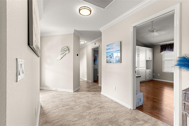 corridor featuring lofted ceiling, ornamental molding, and a textured ceiling