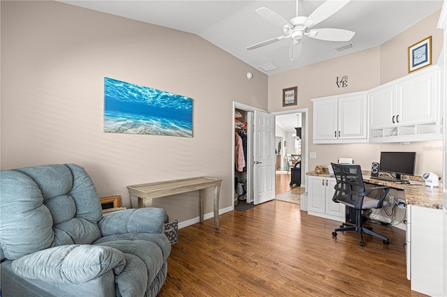 home office featuring ceiling fan, high vaulted ceiling, built in desk, and dark hardwood / wood-style flooring