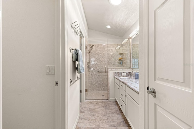 bathroom with vanity, vaulted ceiling, and an enclosed shower