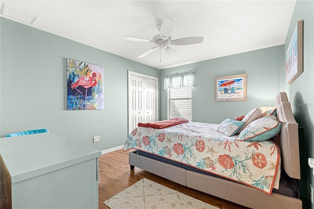 bedroom featuring ceiling fan, a closet, and light wood-type flooring