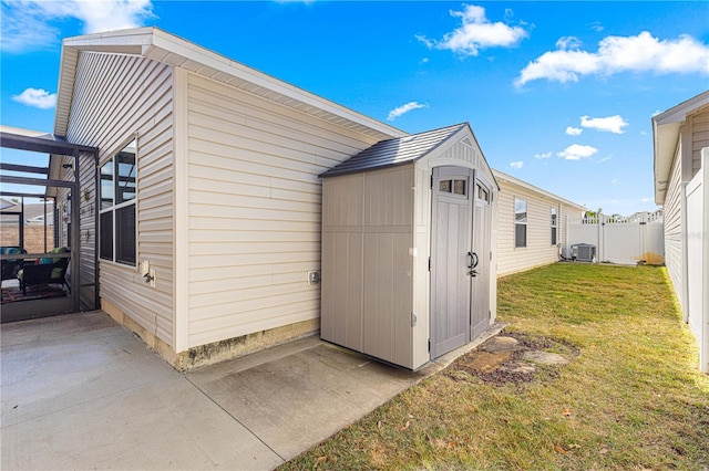 view of outbuilding with a yard and central air condition unit