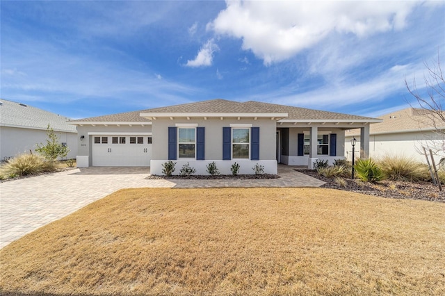 view of front of home with a garage and a front yard