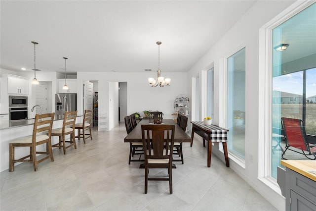 dining area with a healthy amount of sunlight and a chandelier