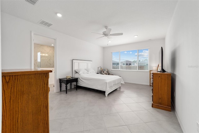 bedroom with ensuite bathroom, light tile patterned flooring, and ceiling fan