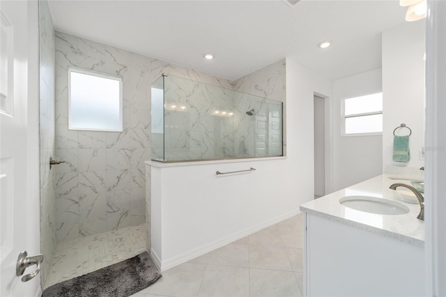 bathroom with vanity, tile patterned floors, and a tile shower