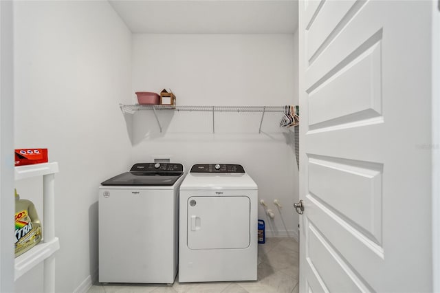 laundry area featuring light tile patterned flooring and washer and dryer