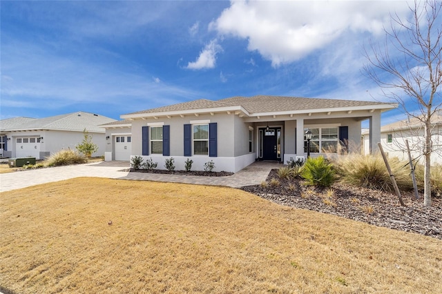 view of front of house with a garage and a front lawn