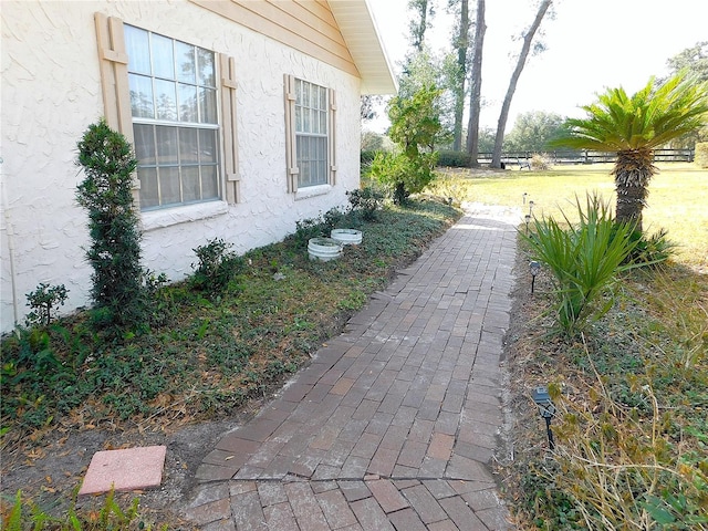 view of property exterior with a lawn