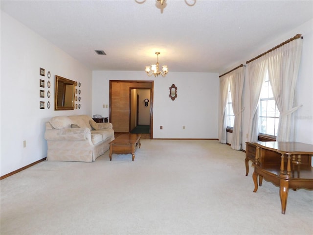 living area featuring a notable chandelier and light colored carpet