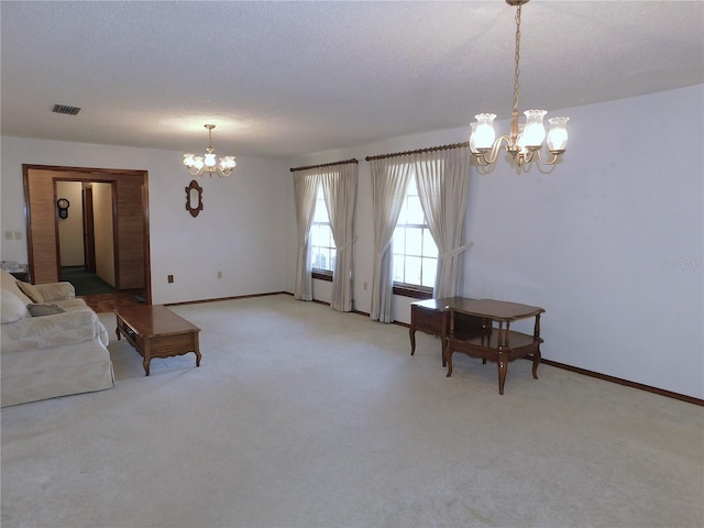 carpeted living room with a textured ceiling and a notable chandelier