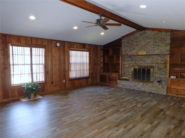 unfurnished living room with dark hardwood / wood-style flooring, a brick fireplace, built in features, and a textured ceiling