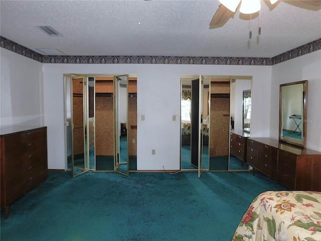 bedroom with dark carpet, a textured ceiling, and ceiling fan