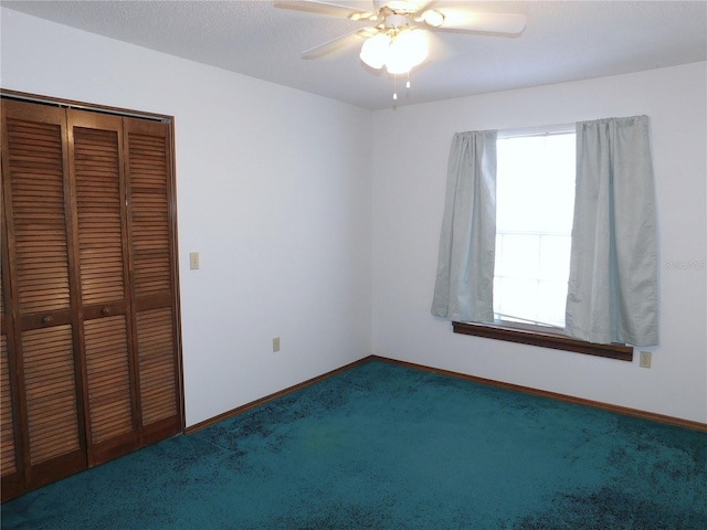 unfurnished bedroom with a closet, ceiling fan, and dark colored carpet