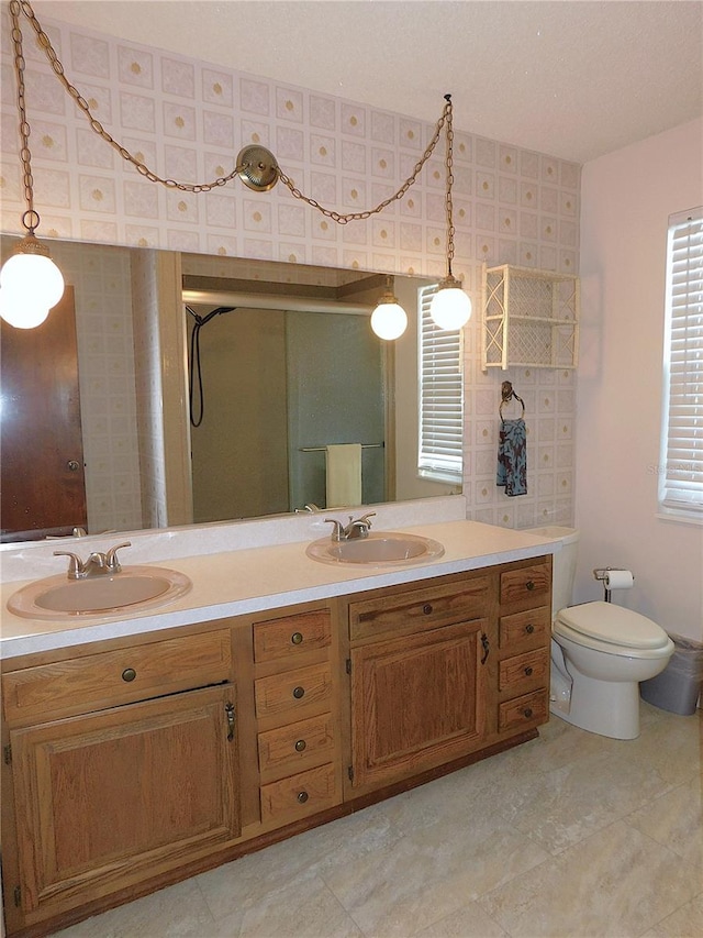 bathroom featuring vanity, toilet, and an enclosed shower