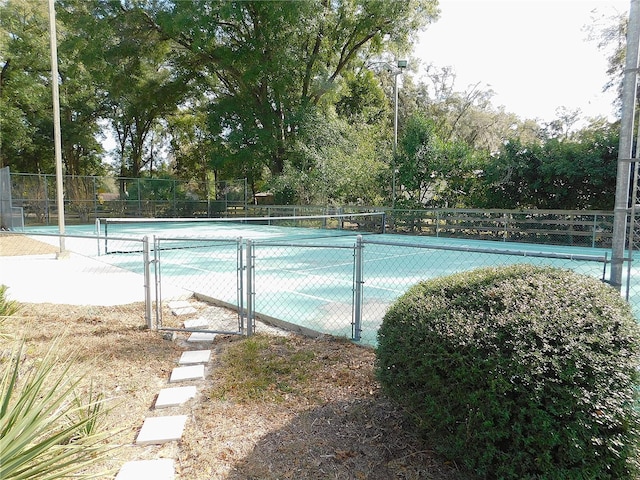 view of pool with tennis court