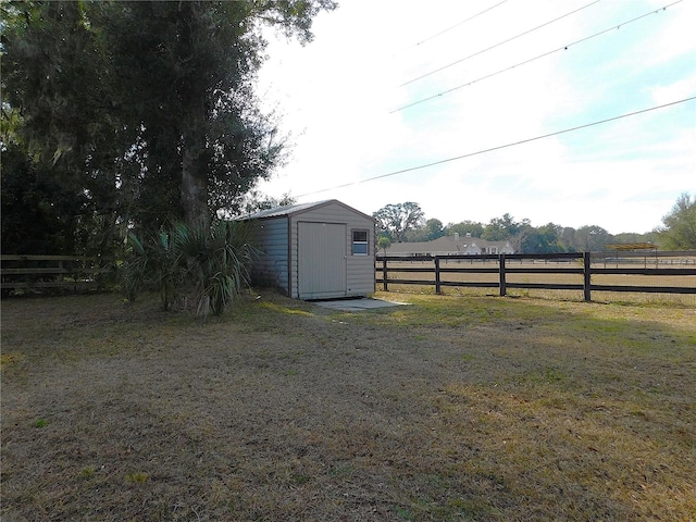 view of yard with a storage unit and a rural view