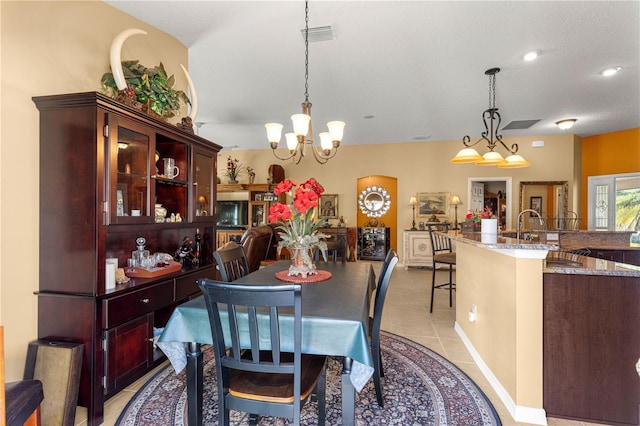 dining space featuring light tile patterned flooring and a notable chandelier