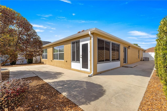 view of property exterior featuring cooling unit and a patio area