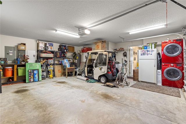 garage featuring white refrigerator, a garage door opener, and stacked washing maching and dryer