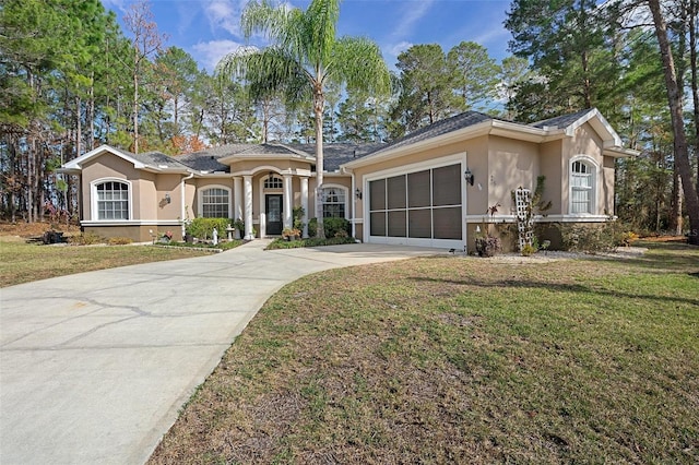 ranch-style house featuring a garage and a front yard