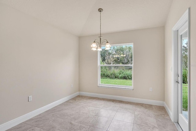 unfurnished room featuring a chandelier