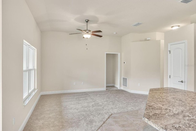 carpeted spare room with ceiling fan