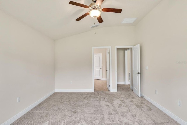 unfurnished bedroom featuring ceiling fan, vaulted ceiling, and light colored carpet