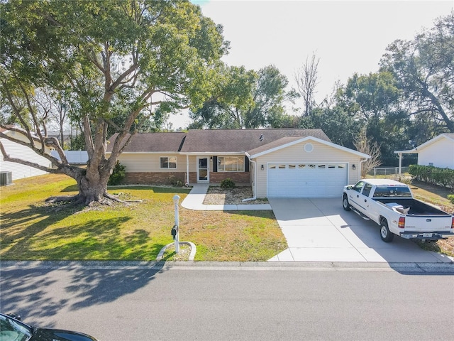 ranch-style house with central AC unit, a garage, and a front yard